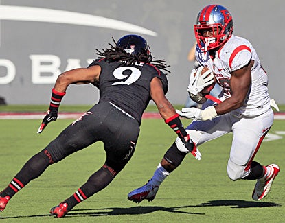Savon Huggins (right) rushes for a career-high 179 yards as Rutgers improves to 9-1 and stays unbeaten in the Big East. (AP)