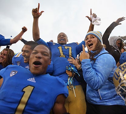 Brett Hundley (17) leads the celebration after UCLA ends its five-game losing streak against the rival Trojans.  (Getty Images)