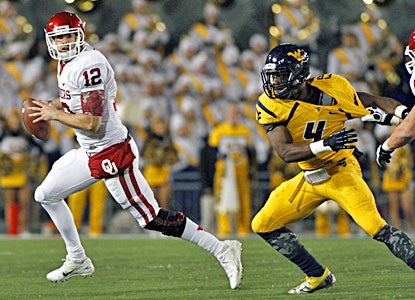 Landry Jones throws six TD passes, including a 5-yarder to Kenny Stills with 24 seconds left to lead the Sooners past WVU. (Getty Images)