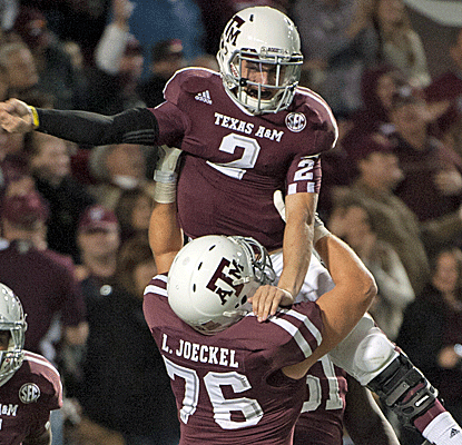 Johnny Manziel continues his Heisman push by accouting for five TDs and throwing for 372 yards.  (AP)