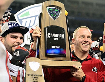 Northern Illinois coach Dave Doeren holds the title trophy after defeating Kent State. His team has a shot at a BCS bowl. (US Presswire)