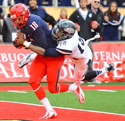 Tyler Slavin secures the winning touchdown with 19 seconds left to cap Arizona's comeback against Nevada.  (US Presswire)