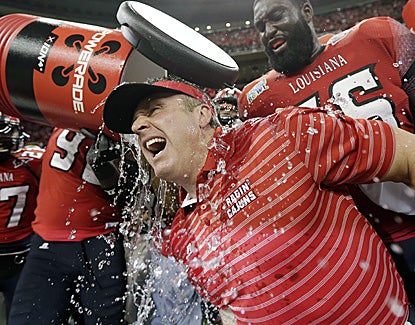 Louisiana-Lafayette coach Mark Hudspeth is dunked at the end of the Ragin' Cajuns' 43-34 win over East Carolina. (AP)