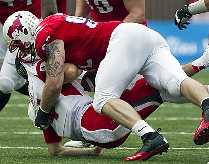 SMU's Margus Hunt tackles Fresno State QB Derek Carr and forces a fumble in the second quarter in the Mustangs' win. (US Presswire)