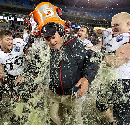 The Bearcats give interim head coach Steve Stripling a postgame shower following their win in the Belk Bowl. (Getty Images)