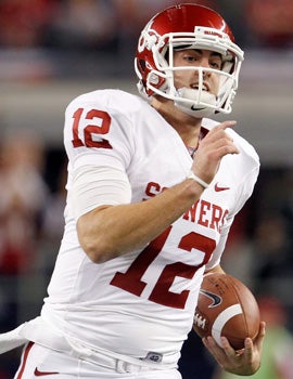 Landry Jones has the size and the arm strength scouts love, but is said to lack the accuracy of fellow Sooner Sam Bradford. (Getty Images)