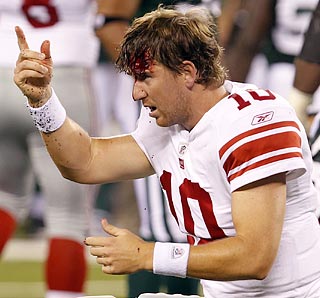 Eli Manning suffers the gash after his helmet flies off when Calvin Pace wallops him.  (US Presswire)