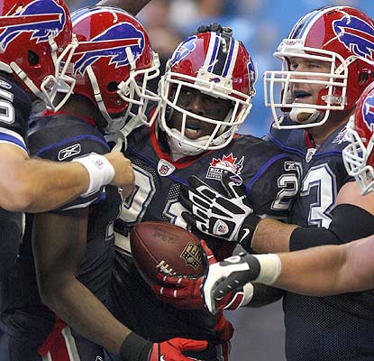 Way to go, rookie: C.J. Spiller takes it to the house from 31 yards and finishes with 54 yards on 10 carries. (US Presswire)