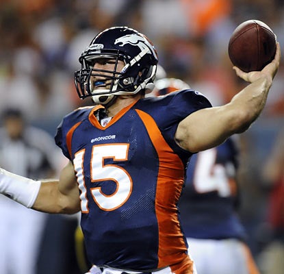 It's not the sharpest home debut for Tim Tebow (5 of 10 for 72 yards, INT) but the Broncos rookie does manage to throw a TD.  (AP)