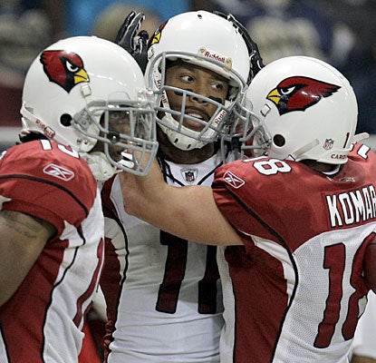 Larry Fitzgerald gets some hugs from teammates after his eventual winning touchdown.  (AP)