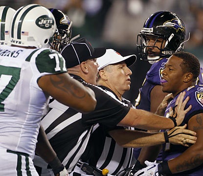 The talking begins early as the Jets' Shaun Ellis (not shown) and Ray Rice get separated by officials before the game.