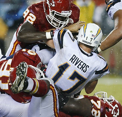 The Chiefs defense flexes its muscles by harassing quarterback Philip Rivers early and often in the season opener.  (AP)