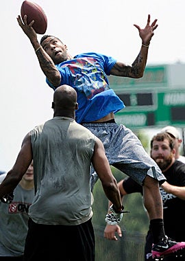 Falcons safety Thomas DeCoud hauls in an interception during a player-organized workout in Buford, Ga. (AP)