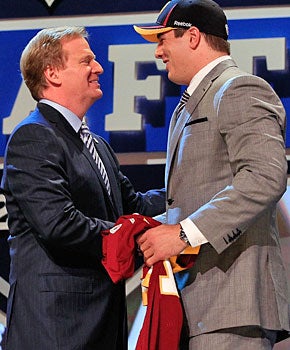 Roger Goodell, getting chummy at the draft with Redskins pick Ryan Kerrigan, isn't really an ogre. (Getty Images)