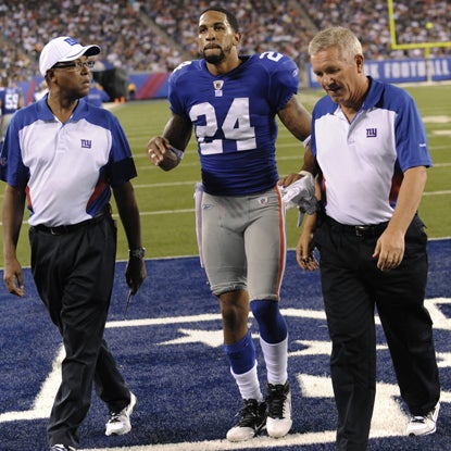 Giants starting cornerback Terrell Thomas hobbles off the field after tearing his ACL in the first half. (Getty Images)