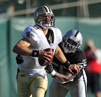 Rolando McClain and the Raiders struggle to contain Drew Brees, who finishes 12 of 23 for 189 yards in the first half. (AP)