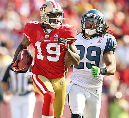 Ted Ginn Jr. outruns Earl Thomas of the Seahawks on his way to a 102-yard kickoff return in the fourth quarter. (Getty Images)