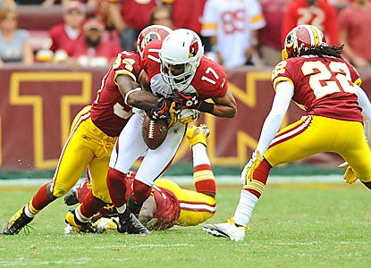 The Redskins' Byron Westbrook (left) forces a fumble by Chansi Stuckey (17), cementing the win.    (US Presswire)