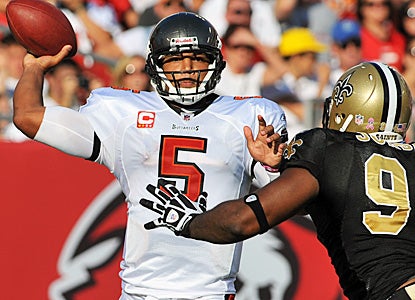 Josh Freeman throws for 303 yards and two touchdowns with no picks to help his team move into a first place tie. (Getty Images)