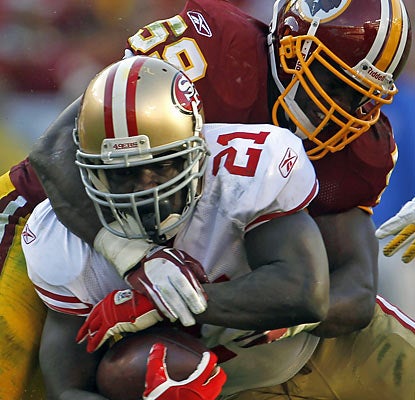 The Redskins fail to contain RB Frank Gore, who produces his fifth consecutive 100-yard game.  (AP)