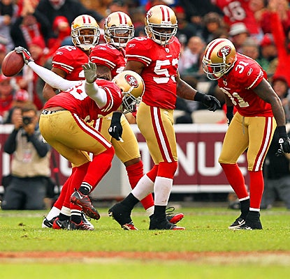The 49ers' Dashon Goldson (left) celebrates an interception with teammates in the third quarter. (Getty Images)