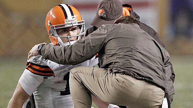 Browns medical staffers attend to McCoy after the QB is laid out by James Harrison. (Getty Images)