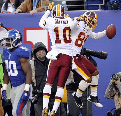 Jabar Gaffney goes airborne to help Santana Moss celebrate his 20-yard touchdown reception.  (AP)