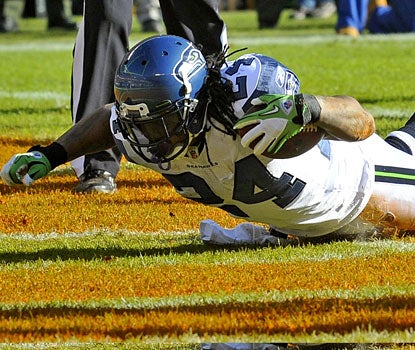 Marshawn Lynch eclipses 1,000 rushing yards and scores twice, extending his touchdown streak to 10 games.  (US Presswire)