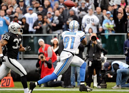 Calvin 'Megatron' Johnson goes for 214 yards on 9 catches to help the Lions extend their wild-card lead. (Getty Images)