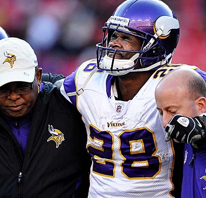 Adrian Peterson is helped off the field after sustaining a game-ending injury in the third quarter vs. the Redskins. (Getty Images)