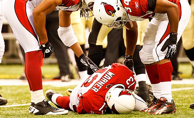 Former Cardinals quarterback Kurt Warner is hurt after taking a hit against the Saints in 2010. (Getty Images)