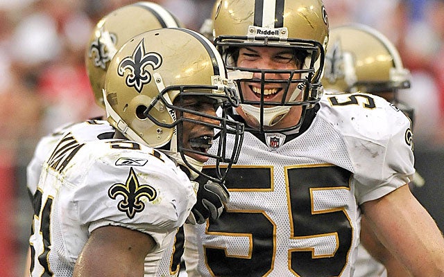 Fujita (55) celebrates Jonathan Vilma interception when the two were Saints teammates. (US Presswire)