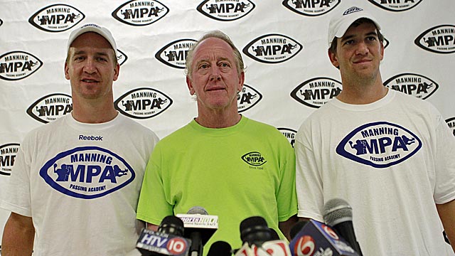 Peyton Manning (left), with father Archie and brother Eli, praises Matt Barkley as a QB. (AP)