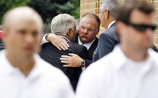 Eagles coach Andy Reid greets people attending his son Garrett's funeral. (AP)