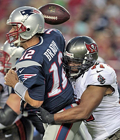 It's a rough outing for Tom Brady, who loses the ball as he is hit by Tampa Bay's Michael Bennett.  (AP)