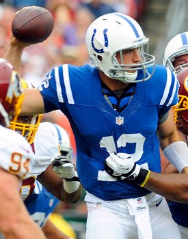 Andrew Luck looks poised, but his offensive line does him no favors Saturday. (AP)