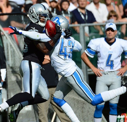 Darius Heyward-Bey makes an amazing catch off the back of Lions defender Justin Miller for a 41-yard gain.   (US Presswire)