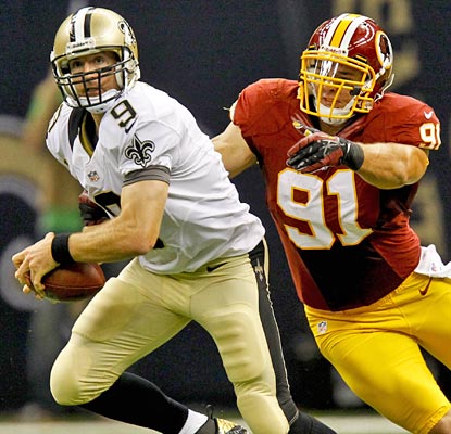 Drew Brees (339 yards, three TDs, two INTs) tries to get away from fellow Purdue Boilermaker Ryan Kerrigan.  (US Presswire)