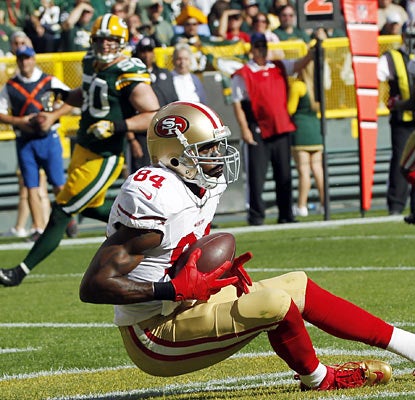 Randy Moss makes his presence felt in his first game since 2010 as he hauls in a TD in the second quarter. (AP)