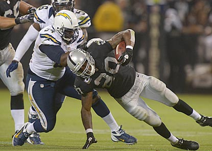Corey Liuget and the Chargers keep Darren McFadden and the Raiders out of the end zone until the final minute.  (US Presswire)