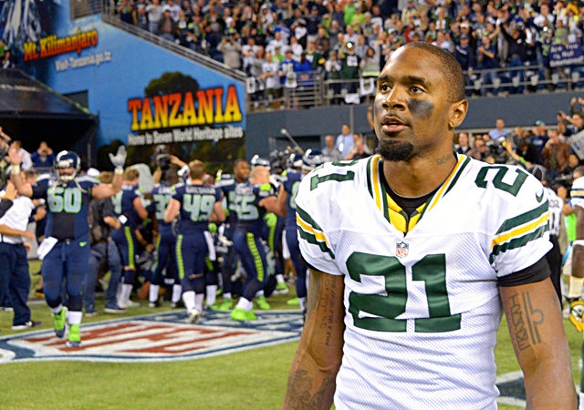Charles Woodson and the Packers walk off the field shocked and in disbelief. (US Presswire)
