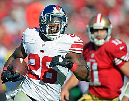 The Giants' Antrel Rolle heads upfield after picking off Alex Smith (right) in the third quarter. (US Presswire)