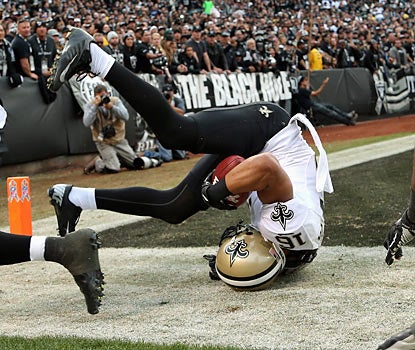 Lance Moore, who scores twice for the Saints, rolls out of the end zone after securing a touchdown grab. (Getty Images)