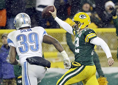 Ricardo Silva is too late to prevent Aaron Rodgers from scoring on a 27-yard run, which gives Green Bay a brief 17-14 lead.  (AP)