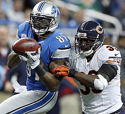 Calvin Johnson beats Charles Tillman for a catch to extend his record but misses the 2,000-yard mark.  (AP)