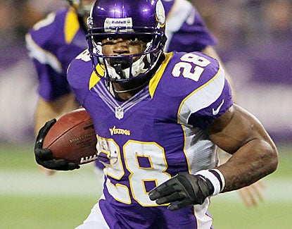 Adrian Peterson rushes for 199 yards on a career-high 34 carries against a Packers defense designed to stop him. (Getty Images)