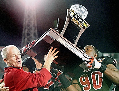 Arkansas State interim head coach John Thompson and Ronnell Wright lift the trophy after knocking off No. 25 Kent State. (US Presswire)