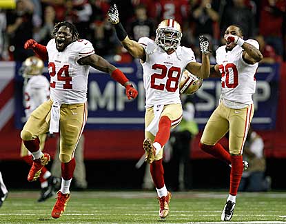 Anthony Dixon (left), Darcel McBath (center) and Perrish Cox celebrate a late defensive stop. (Getty Images)