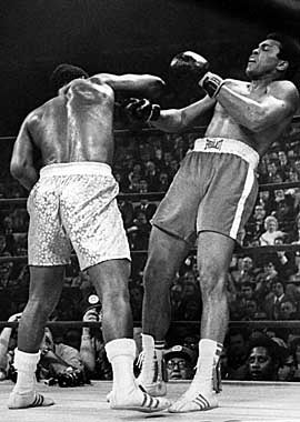 Then champ Joe Frazier knocks down Muhammad Ali in the first of their three epic matches. (Getty Images)