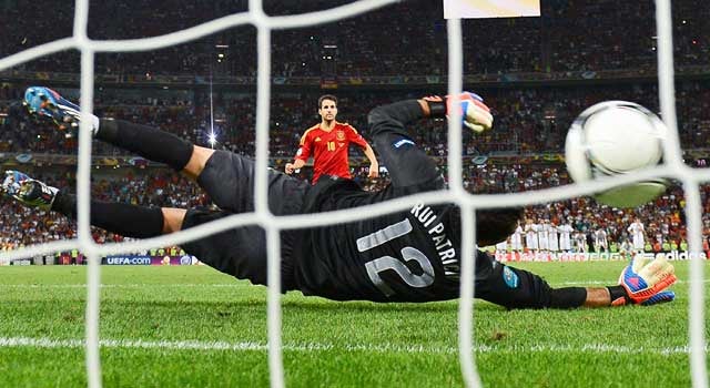 Spain's Cesc Fabregas scores the winning goal against Portugal goalie Rui Patricio in the penalty shootout. (AP)